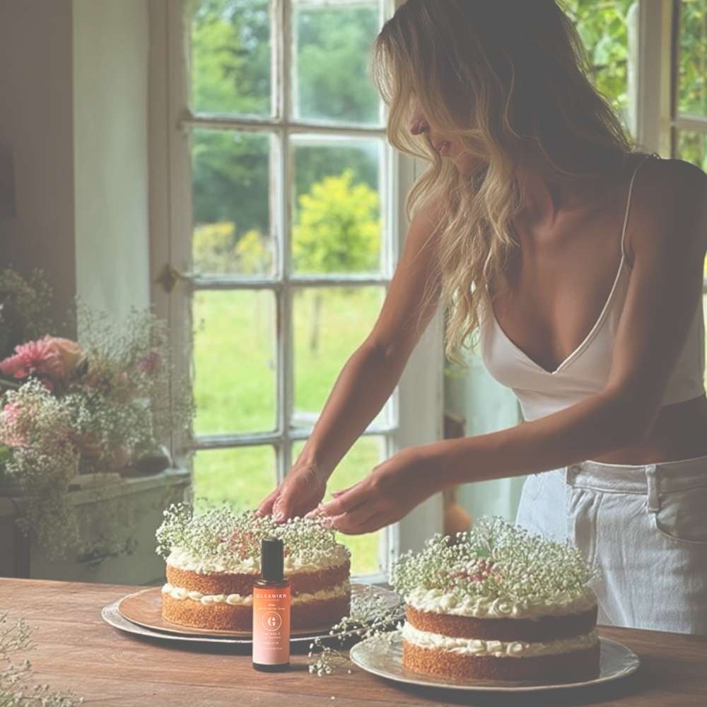 Aesthetic lifestyle shot of a woman arranging cakes by a window, featuring Gleamier’s bin deodoriser spray as a natural way to neutralise kitchen odours.